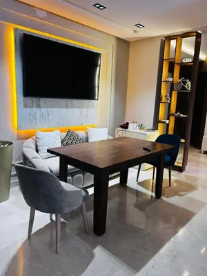 a living room with a table and a couch at Luxury apartment in Oulad Mbark