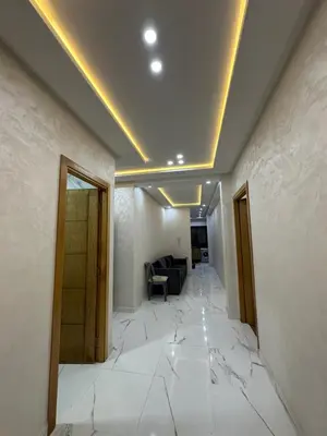 a room with a white tile floor with a cracked ceiling at Apparemment propre pour les familles in Casablanca