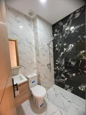 a bathroom with a white toilet and a sink at Apparemment propre pour les familles in Casablanca