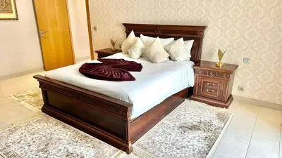 a bedroom with a large bed with white sheets at Ocean View 2 Bedroom Apartment in Casablanca