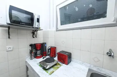 a kitchen with a counter with a microwave and a counter top at Hamouda Tabina in Rabat