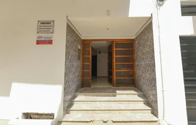 a hallway of a building with wooden doors and stairs at Hamouda Tabina in Rabat