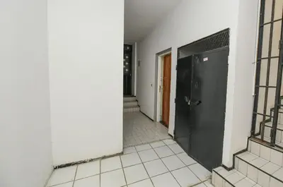 an empty hallway with a black door and a tile floor at Hamouda Tabina in Rabat