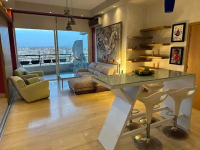 a living room with a table and a couch at Terrace & View of Casablanca Port in Casablanca