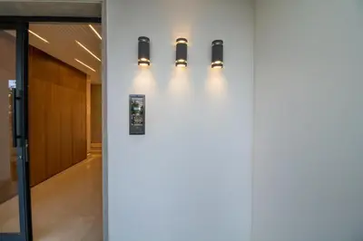 a hallway with three lights on a wall at Joli Studio au Cœur de CFC En Face Aeria Mall in Casablanca