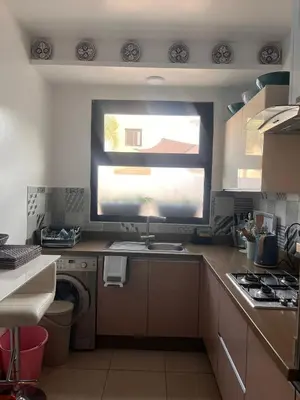 a kitchen with a sink and a window in it at The Blue Beach apartment- Residence Skhirat Beach2 in Skhirat