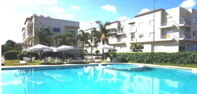 a large swimming pool in front of a building at Bel Appart dans une résidence balneaire in Tamaris