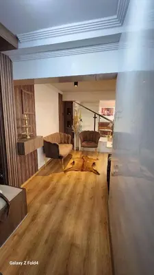 a living room with two chairs and a table at Apartment in Harhoura in El Harhoura