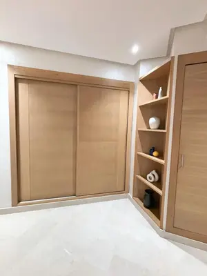 a closet with wooden doors in a room at Votre Cocon Moderne - Central & tout confort in Casablanca