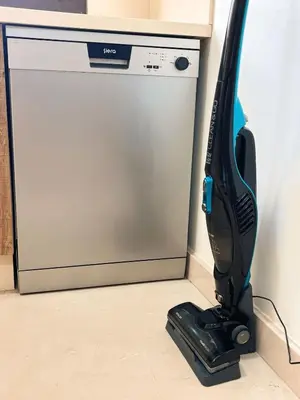 a vacuum cleaner on the floor next to a dishwasher at Votre Cocon Moderne - Central & tout confort in Casablanca