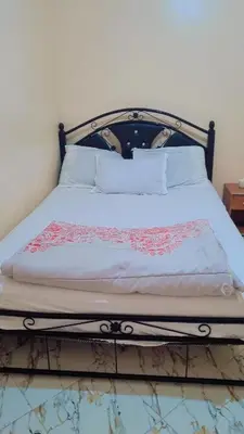 a bed with white sheets and pillows in a room at Chez binette in Casablanca