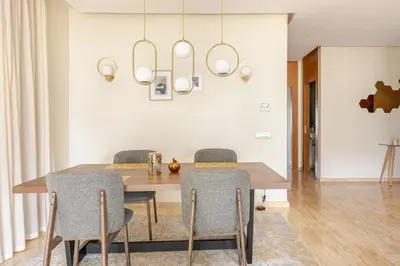 a dining room with a wooden table and chairs at Harcay CFC in Casablanca