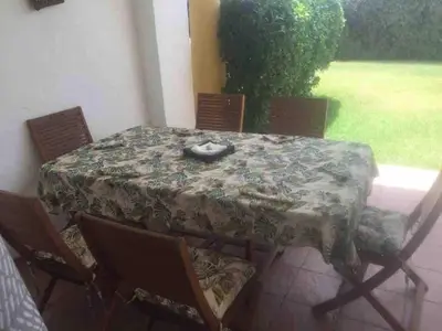 a table with chairs and a table cloth on it at Appart face à la mer Garden Beach Sidi Rahal plage in Sidi Rahal