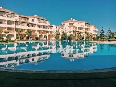 a large swimming pool in front of a building at Appart face à la mer Garden Beach Sidi Rahal plage in Sidi Rahal
