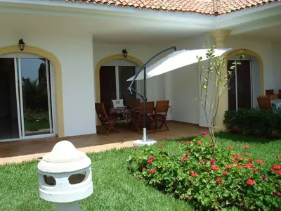 a white fire hydrant in the yard of a house at Appart face à la mer Garden Beach Sidi Rahal plage in Sidi Rahal