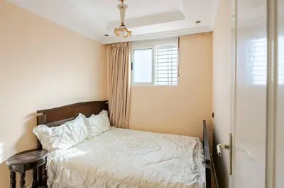 a small bedroom with a bed and a window at Layover Guest House - Studio Rabat City Center - 4th Floor in Rabat
