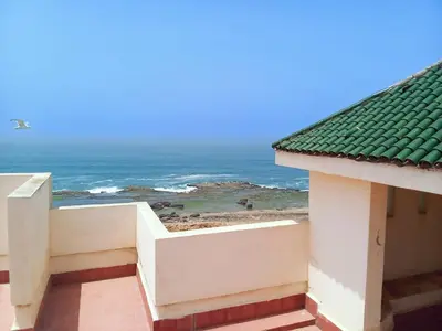 a view of the ocean from a building at Apartment with terrace breathtaking ocean views in Rabat