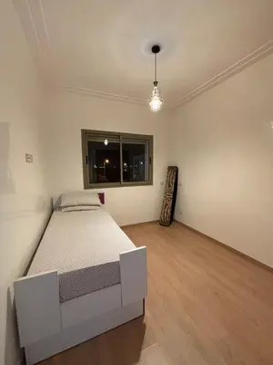a bedroom with a bed and a window at Appartement familiale in Tamaris