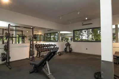 a gym with rows of exercise equipment and windows at Skyline Retreat in Casablanca