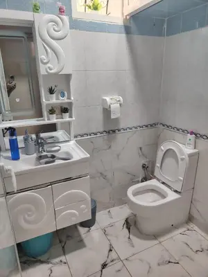 a bathroom with a white toilet and a sink at Casa Hasna in Casablanca