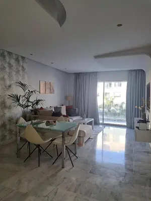 a living room with a table and a couch at Holiday Appart in Casablanca