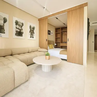 a living room with a couch and a bed at Scandi Design Central Casablanca in Casablanca