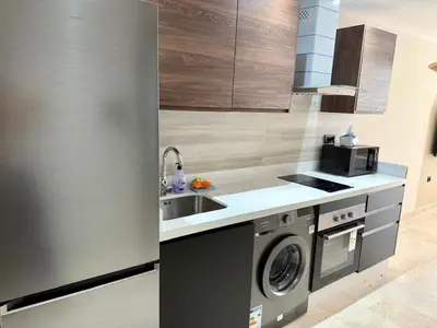 a kitchen with a sink and a washing machine at Scandi Design Central Casablanca in Casablanca