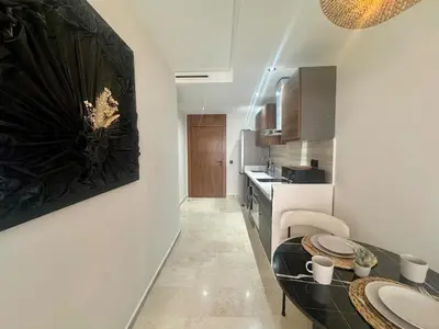 a kitchen with a table and a sink in a room at Scandi Design Central Casablanca in Casablanca