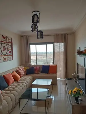 a living room with a couch and a table at 2 Bedrooms Blanca Beach in Sidi Rahal