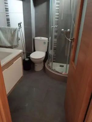 a bathroom with a toilet and a glass shower at 2 Bedrooms Blanca Beach in Sidi Rahal