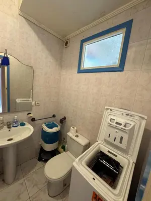 a bathroom with a toilet and a sink and a window at Appartement pour la CAN, Palm Beach - Mansouria in Mohammedia