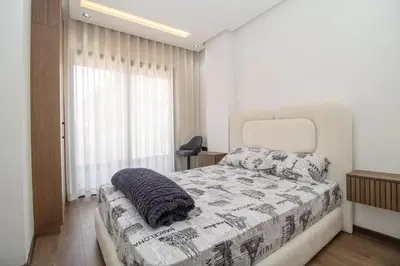 a bedroom with a bed with a blanket on it at Modern Studio 5min CFC in Casablanca