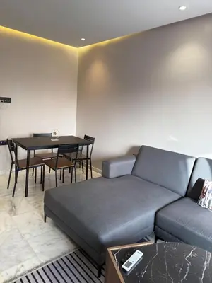 a living room with a couch and a table at Luxury Apartment 5min CFC in Anfa
