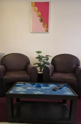 a living room with two chairs and a coffee table at Parisien Studio in Rabat