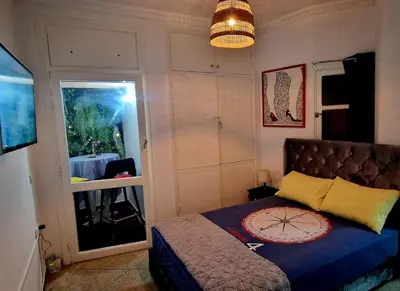 a small bedroom with a bed and a window at Nice studio for nice people in Rabat