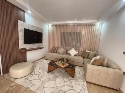 a living room with a couch and a coffee table at Appartement pieds sur mer in Sidi Rahal