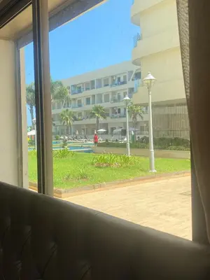 a view of a building from a window at Appartement neuf avec piscine in Bouznika