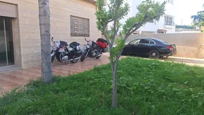 a couple of motorcycles parked next to a building at Chambres au sein d'une villa in Rabat