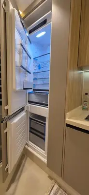 an empty refrigerator with its door open in a kitchen at Rabat Residence - OCEAN STAY 2 in Rabat