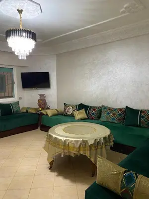 a living room with a couch and a table at Très bel Appartement A Darbouazza Tamaris in Tamaris