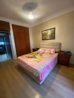 a bedroom with a large bed in a room at Très bel Appartement A Darbouazza Tamaris in Tamaris