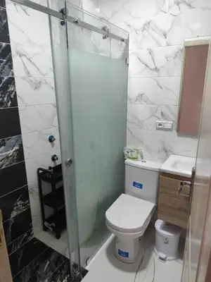 a bathroom with a toilet and a glass shower at Nid d'anges in Bouznika