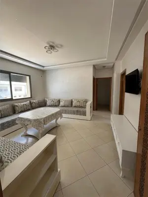 a living room with a couch and a table at Apartment for rent el mansoria in Mansouria