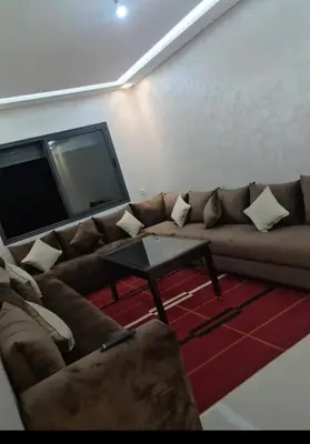 a living room with a couch and a flat screen tv at Maison vacances à bouznika in Bouznika
