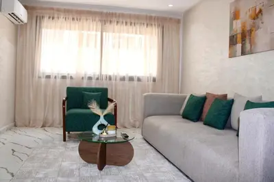 a living room with a couch and a table at Holiday Harmony in Roches Noires