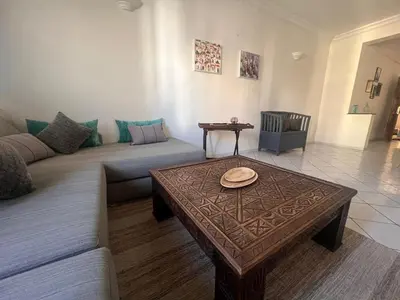 a living room with a couch and a coffee table at Maarif Central Stay 2 in Maarif