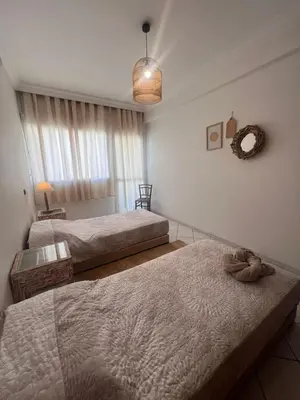 a bedroom with two beds and a window at Maarif Central Stay 2 in Maarif