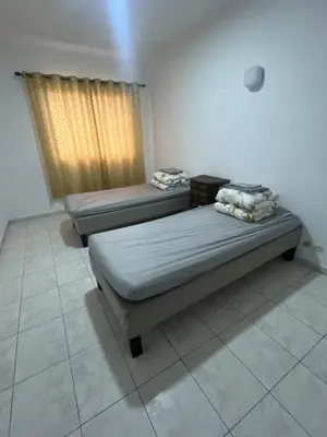 two beds in a room with a window at Happy hostel in Casablanca