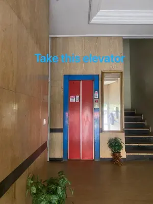 a red and blue door in a building with stairs at Happy hostel in Casablanca