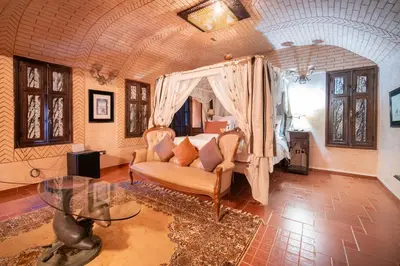 a bedroom with a bed and a couch in a room at Lakala Complexe Touristique in O Ben Slimane
